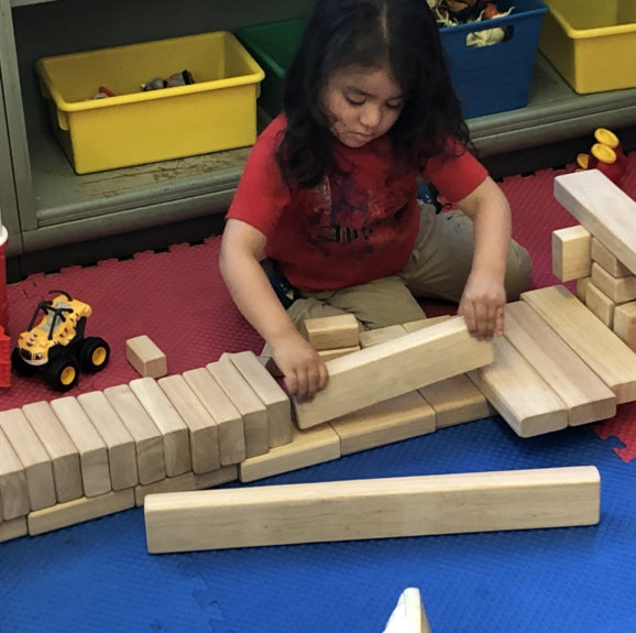 kid playing wooden blocks