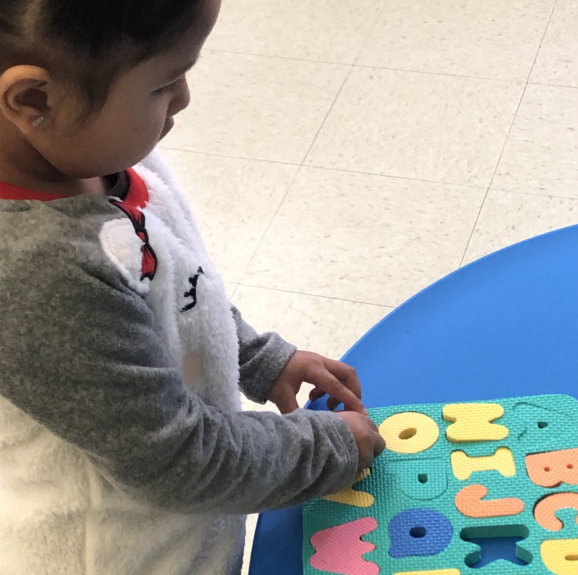 kid playing alphabet