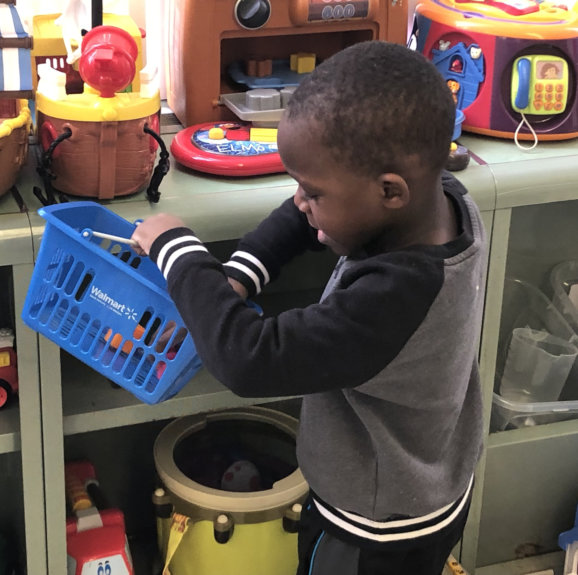 kid holding a basket